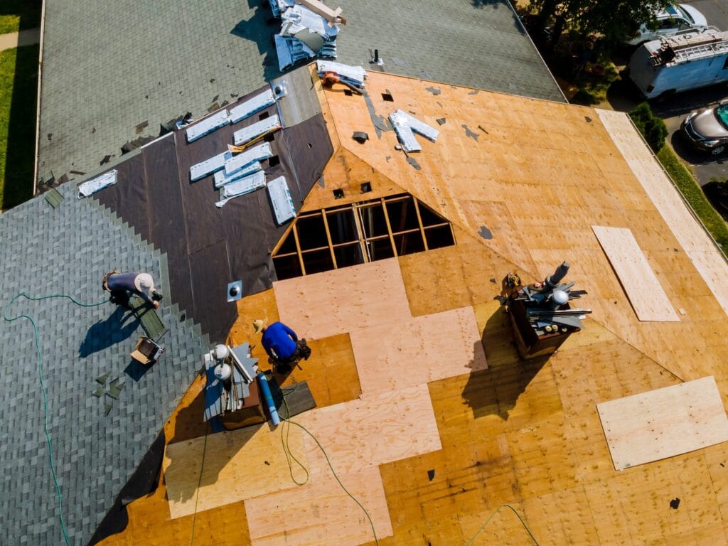 Professional roofing contractor installing new shingles Ormond Beach FL property